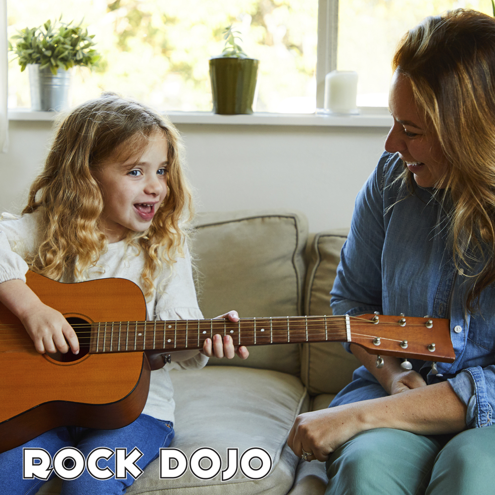 mother teaching her daughter the benefits of music education on a guitar.