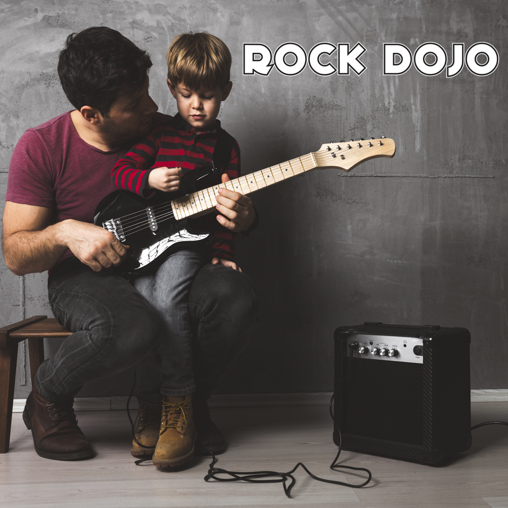 A father teaching his son how to play guitar. Benefits of music Education