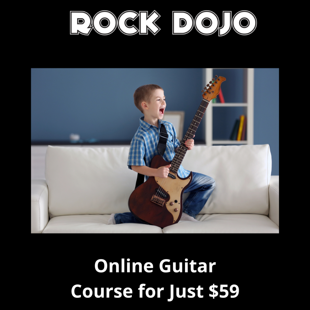 child enjoying playing guitar as he plays his favorite guitar songs for kids.