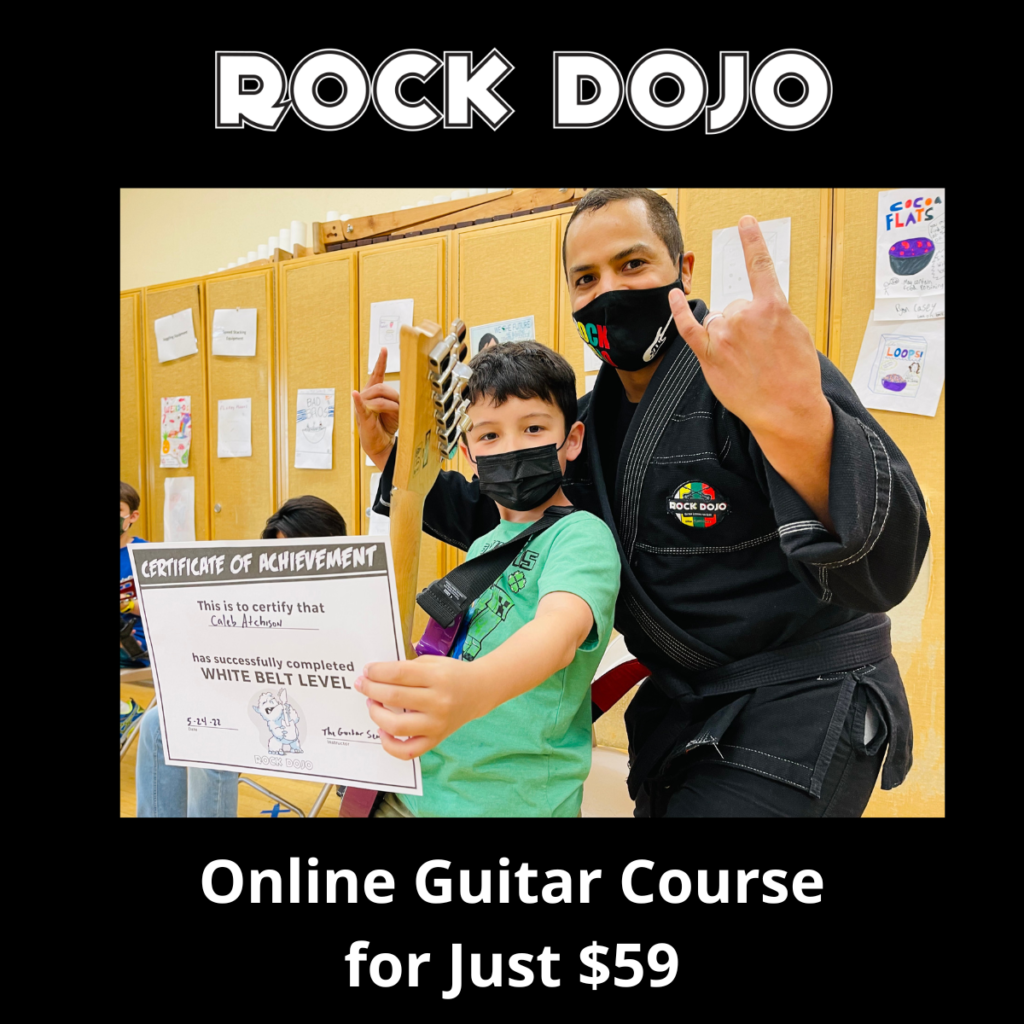 A child holds a certificate of completion, proud of their accomplishments at the Rock Dojo guitar course for kids. Rock Dojo helps build a strong guitar foundation for kids.