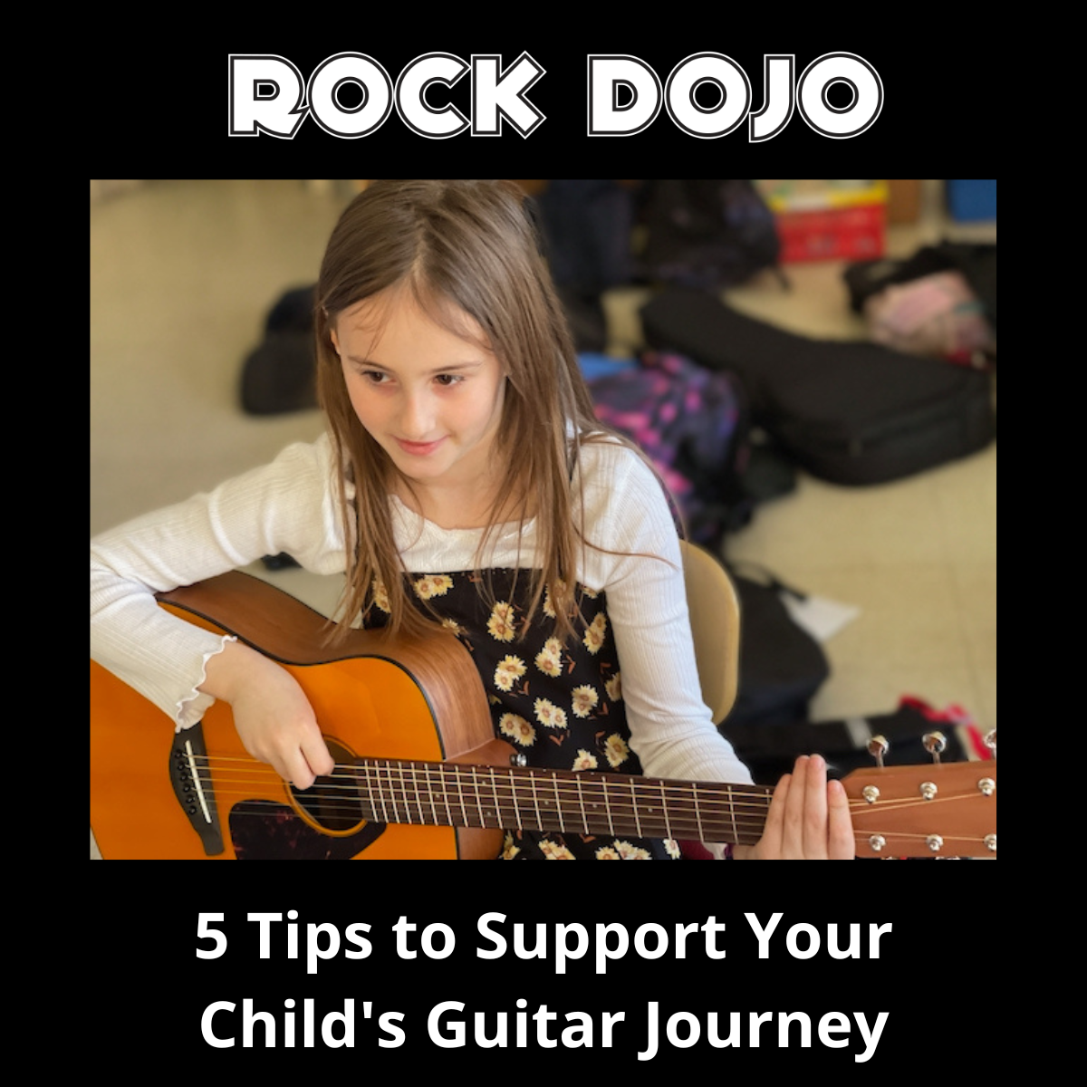 Little girl playing the guitar in the Rock Dojo after-school program for kids on a guitar journey.