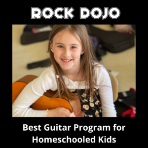 Smiling girl playing guitar as part of homeschool guitar program