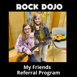 Two little girls smiling and making the rock sign with their hands to promote Rock Dojo's referral program.