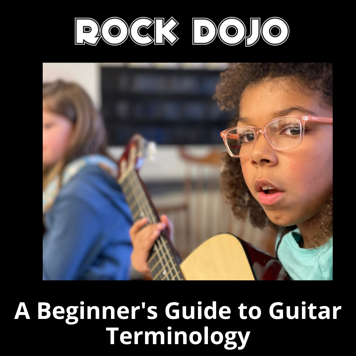A child playing the guitar during Rock Dojo's after-school guitar lessons for children.