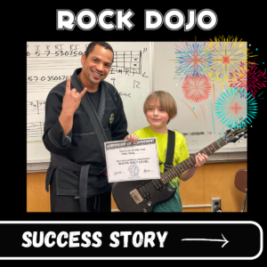 Evan and Guitar Sensei holding Rock Dojo White Belt certificate, Evan wearing white belt wristband