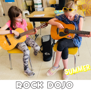 Kids enjoying summer guitar lessons with Rock Dojo, playing acoustic guitars in a classroom setting.