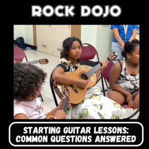 Children learning to play the guitar in a Rock Dojo classroom, highlighting the start of their guitar lessons journey.