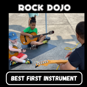 Two young children learning guitar at Rock Dojo, the best first instrument for kids.