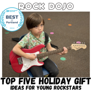 A young boy playing a red electric guitar at Rock Dojo, highlighting the best guitar gifts for kids this holiday season.